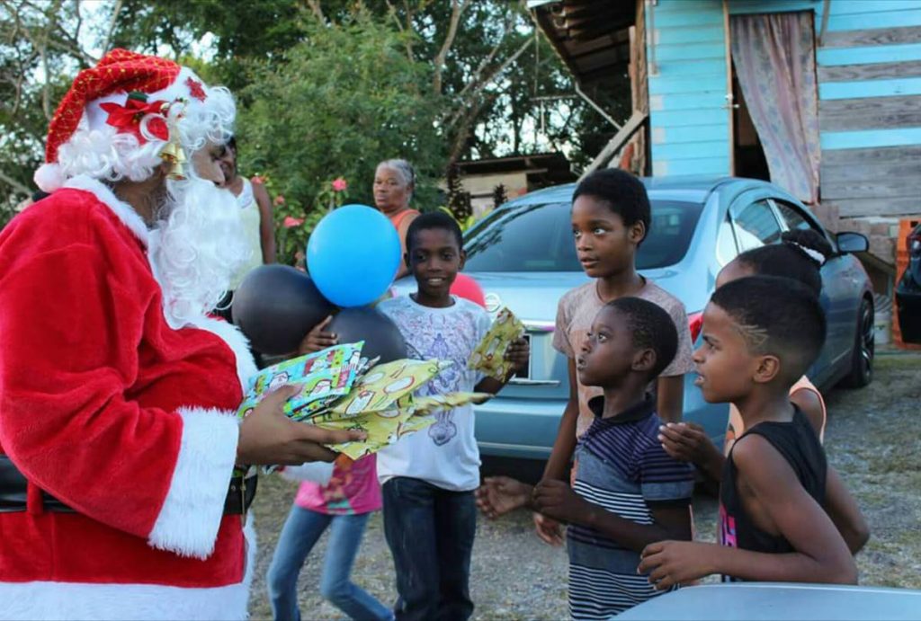 File photo: Alex Sieunarine, son of Preysal businessman Allan Sieunarine, is dressed as Santa Claus as he delivers gifts gifts to children in Woodland in 2017. 
