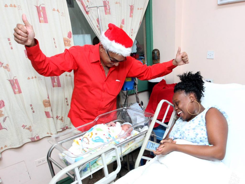 SANTA TERRENCE: Health Minister Terrence Deyalingh celebrates with Reneisha La Croix the birth of her son, unnamed at the time, yesterday at the Port of Spain General Hospital.