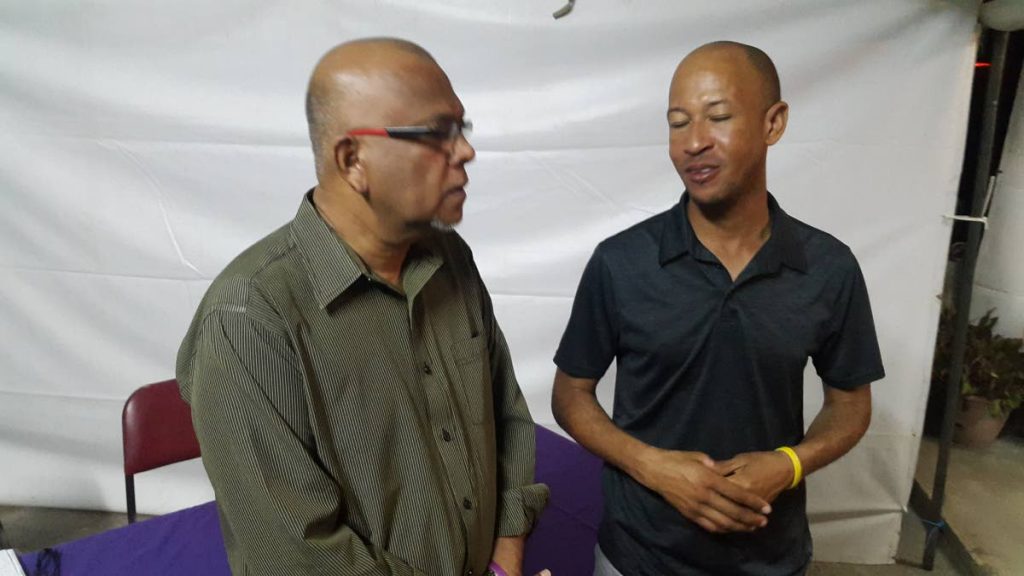 CRICKET TALK: Jamaican cricket umpire Verdayne Smith, right, chats with Azim Bassarath, president of President’s Associates Cricket Club.