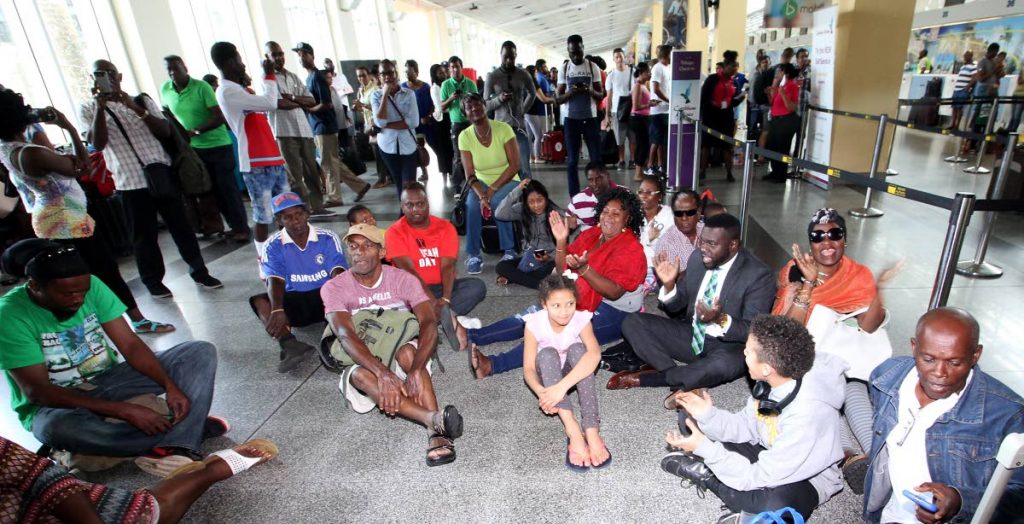 Sit in: PSA president and THA Minority Leader Watson Duke sits among passengers stranded at Piarco International Airport following CAL's cancellation of flights to Tobago. Photo by Roger Jacob