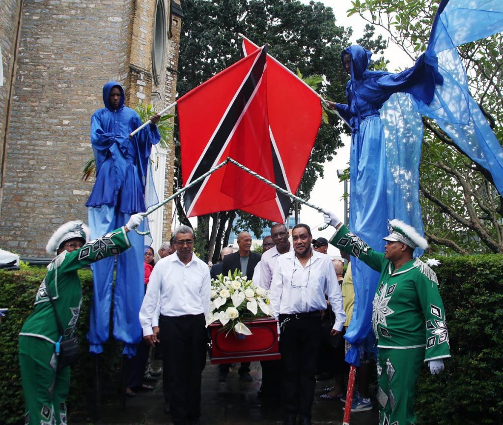 SEND OFF: The body of veteran masman McDonald “Mac” Ward is taken from the Holy Trinity Cathedral, Abercromby Street in Port of Spain after a funeral service was held in his honour.  Traditional mas characters formed a guard of honour over the casket.