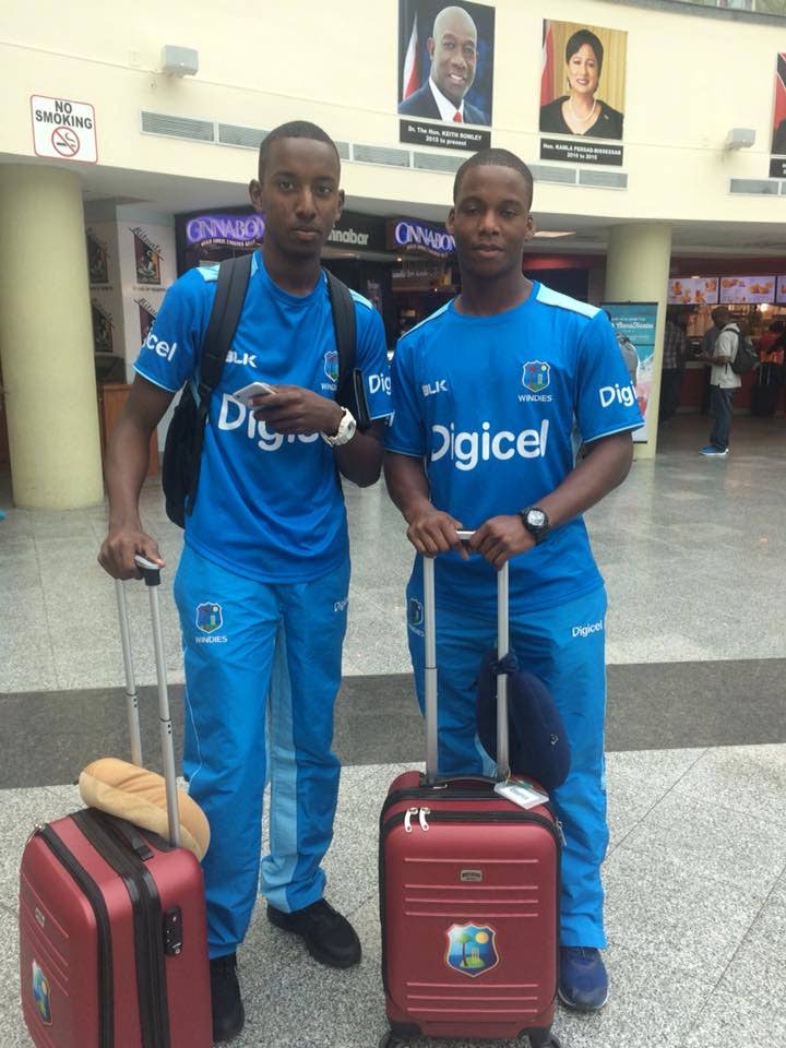 Trinidad and Tobago’s Keagan Simmons, left, and Cephas Cooper, right, at the Piarco International Airport yesterday ahead of their 
departure for Barbados to join the West Indies Under-19 team before they leave for the ICC U-19 World Cup in New Zealand.