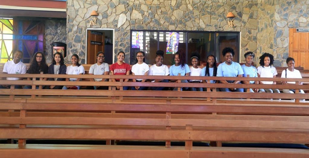 Members of the tourism clubs sit in the Our Lady of Guadulape Church in Paramin.