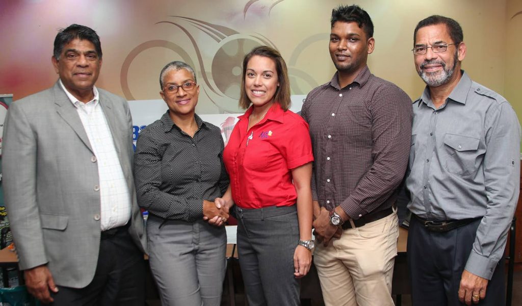 LAUNCH: From 2nd left, Dianne Henderson, chairperson of TTIM shakes hands with Kiss baking representative Sarah Jones as Diabetes Association vice president  Andrew Dhanoo, Francis William Smith, director at TTIM, and at left, Tony Harford TTIM member looks on during the launch of the 2018 TT International Marathon at Olympic House, Port of Spain.