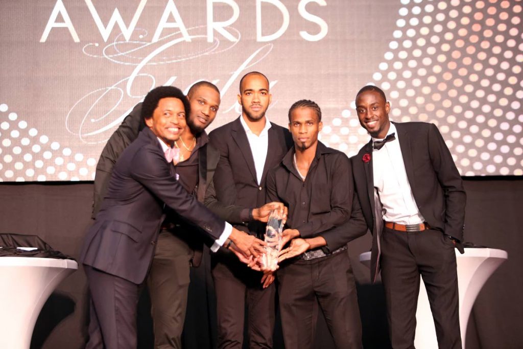 TT Olympic Committee boss Brian Lewis, left, joins World 4x400m champs (from left) Lalonde Gordon, Machel Cedenio, Renny Quow and Jereem Richards after they won the TTOC Sportsman of the Year award on Friday at the Hyatt Regency, Port of Spain.