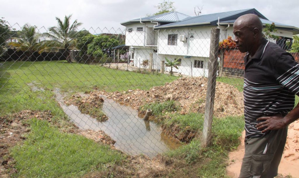 Carlton Williams explains the water woes the residents of Frank Hart Street in Arima are facing because of a burst main.