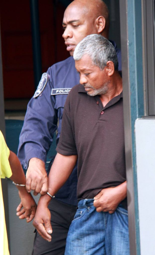 TO JAIL: Harripersad Roopchand is taken to the Siparia magistrates court where he was denied bail after being charged with maliciously wounding his estrange d wife Shanti Roopchand and son Premchand.