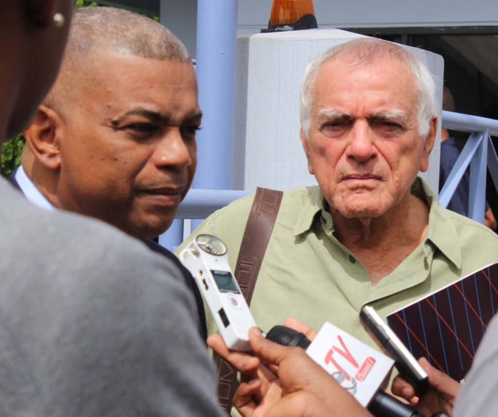 Peter Permelle and Emile Elias talking to media yesterday outside the Trinidad and Tobago Security Exchange Commission. Both are shareholders in Guardian Holdings. PHOTO BY ENRIQUE ASSOON. 