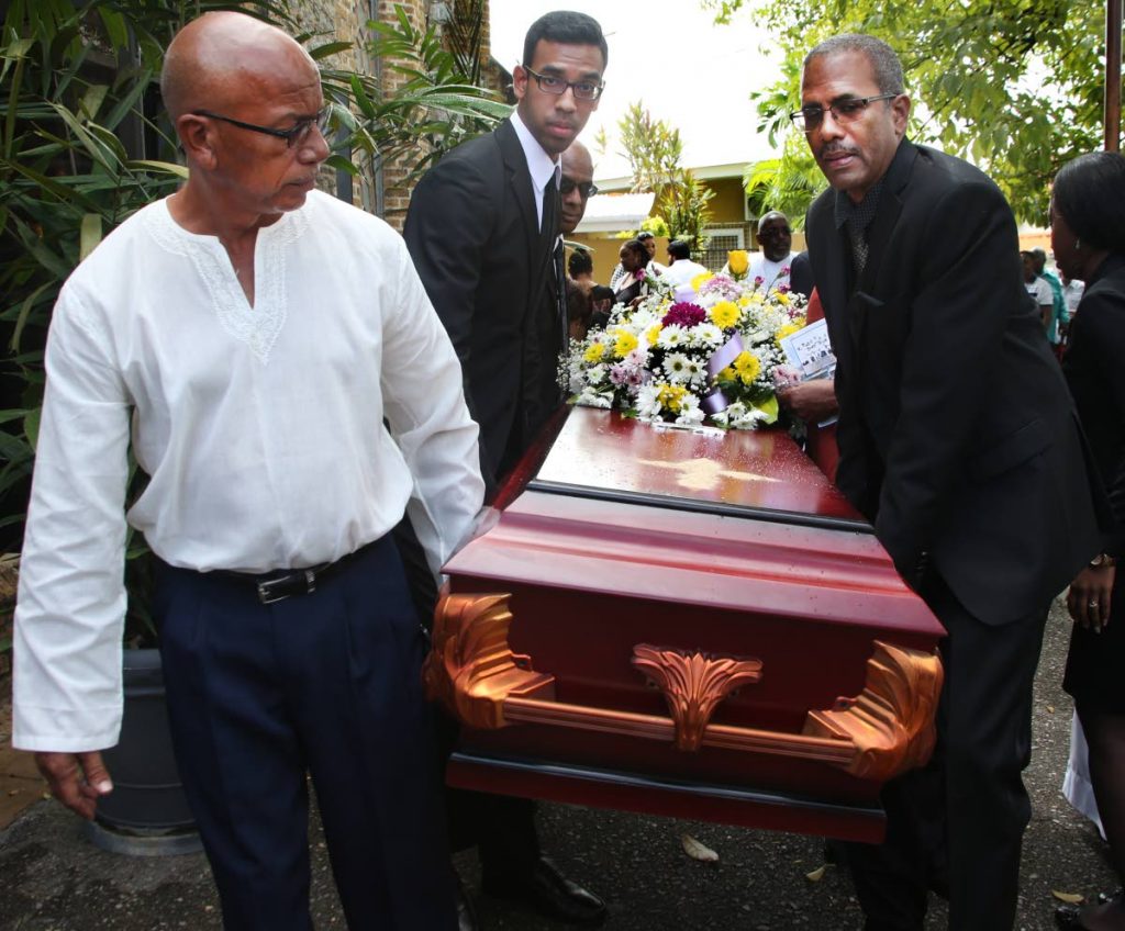 Pallbearers carry the body of the late veteran TT and international  cricket umpire Clyde Cummerbatch following his funeral at the All Saints Anglican Church, Marli St, PoS yesterday.