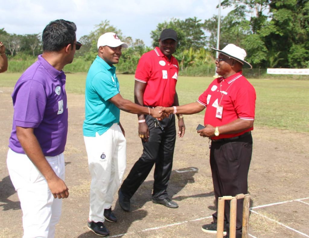 Brian Lara, second from left, shakes the hand of an umpire as Daren Ganga, left, looks on at the start of a T20 charity match on Saturday in Barrackpore.