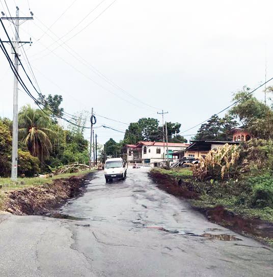 NIGHTMARE ROAD: A landslip in Agostini Village, Rio Claro has caused this section of the Naparima Mayaro Road to sink and warp, creating a hazard for both motorists and pedestrians.