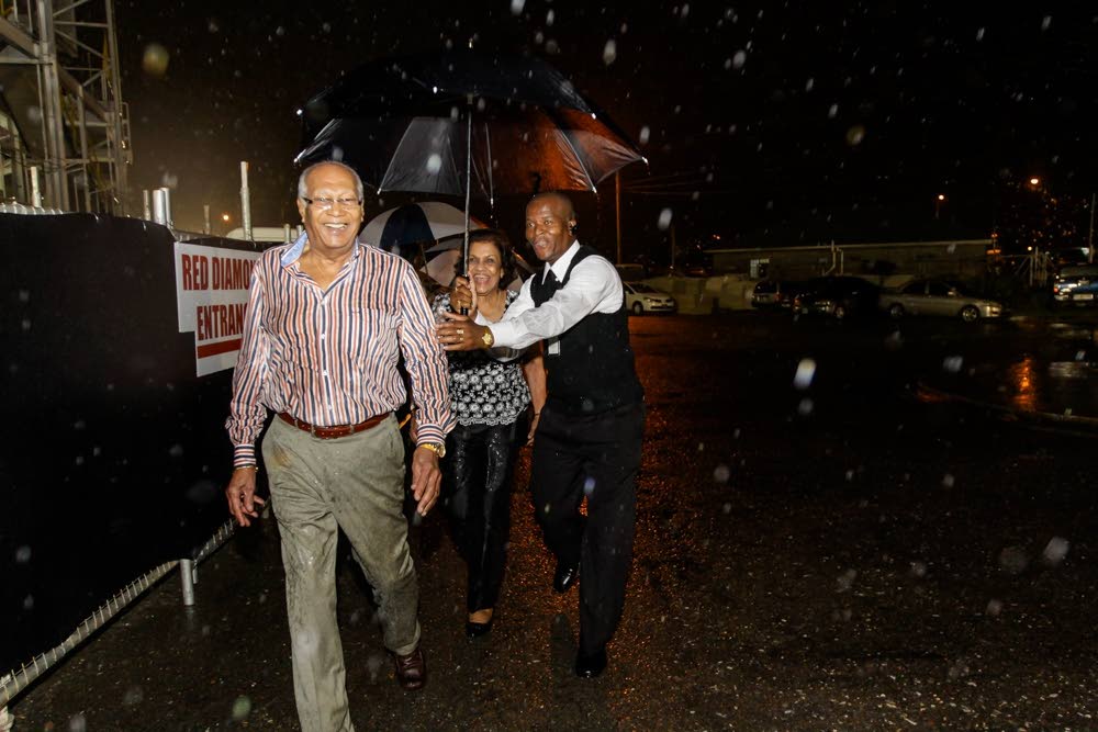 JUST A LITTLE RAIN: Late former President Prof George Maxwell Richards was not afraid to brave a heavy downpour at an event he and his wife attended while he was in office.  Many have hailed him as a man of the people.