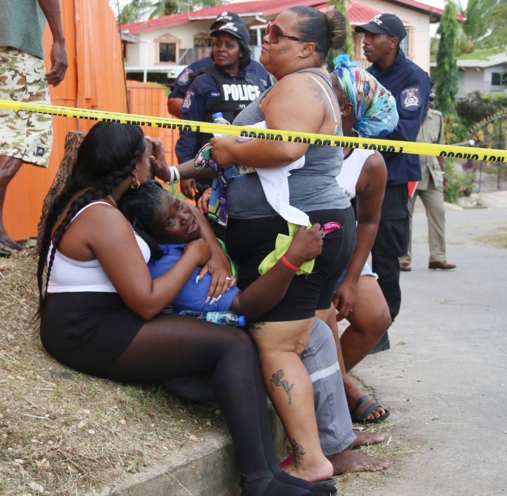 THEY KILLED MY SON: Cleopatra Wilson is inconsolable at the scene where her 30-year-old son Akeemie Wilson and his friend Jahmie Donaldson, 26, were shot dead in Pleasantville yesterday.   PHOTO BY ANSEL JEBODH