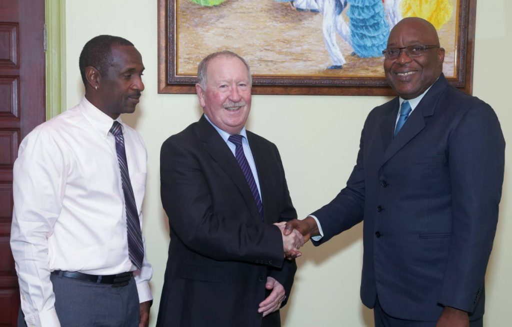 Union of European Football Associations (UEFA) certified British coach Jim Kelman, centre, paid a courtesy call on THA Chief Secretary Kelvin Charles at the Administrative Complex, on Wednesday (January 10). 
With them, left, is Department of Sport coach supervisor Peter Granville.
