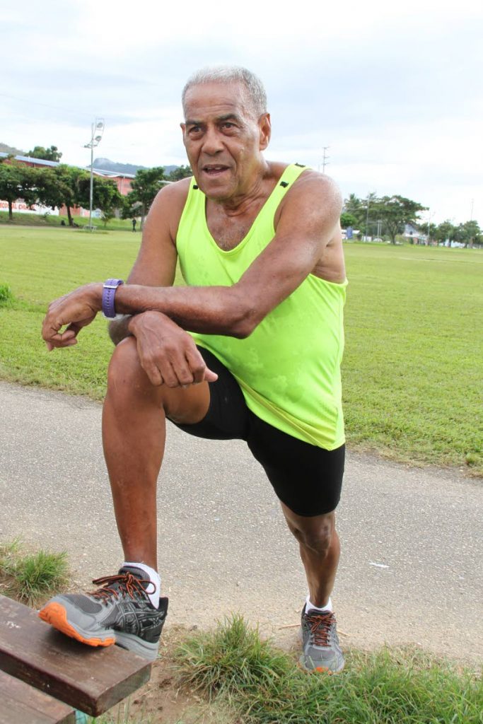 Veteran runner Derrick Mc Intyre stretches during a training session on Thursday morning at the Aranguez Savannah.