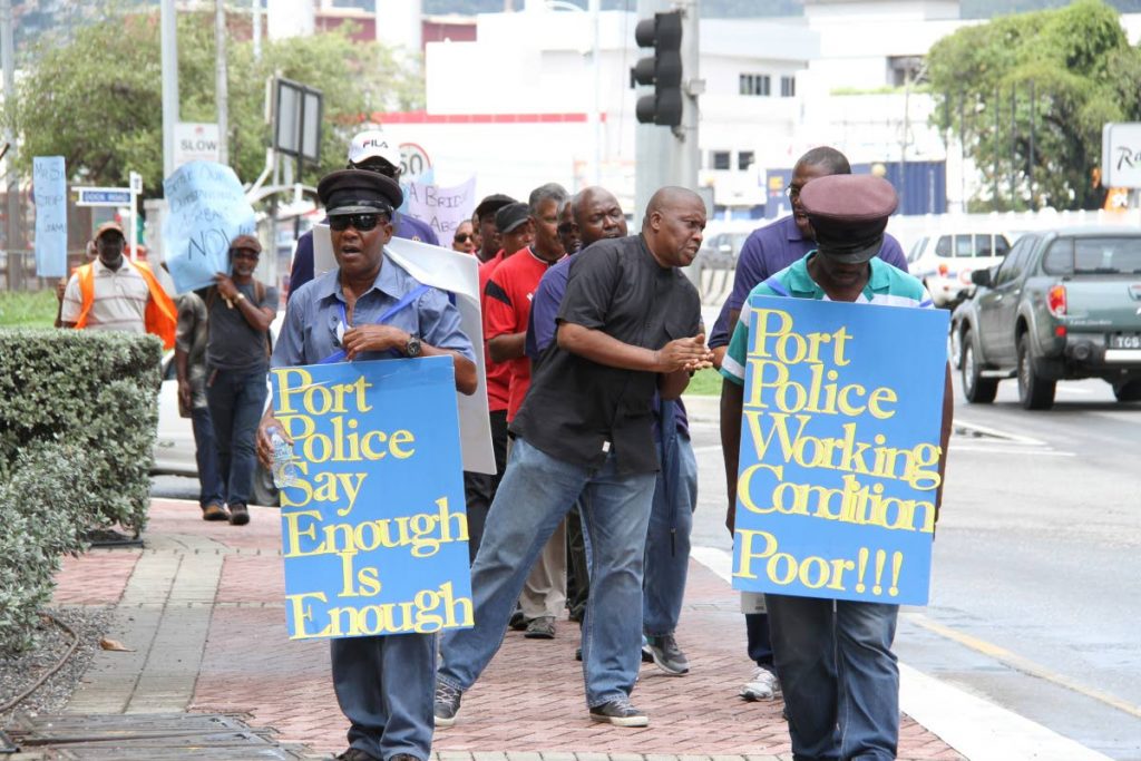 ON THE MOVE: Members of the Port Authority branch of the Estate Police Association during their peace walk outside the Parliament building at Wrightson Road, Port of Spain yesterday.