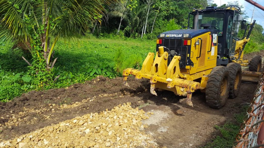 A bulldozer spreads gravel on a roadway which lobby Fishermen and Friends of the Sea claims is part of the preparation works for the new Manzanilla Highway.