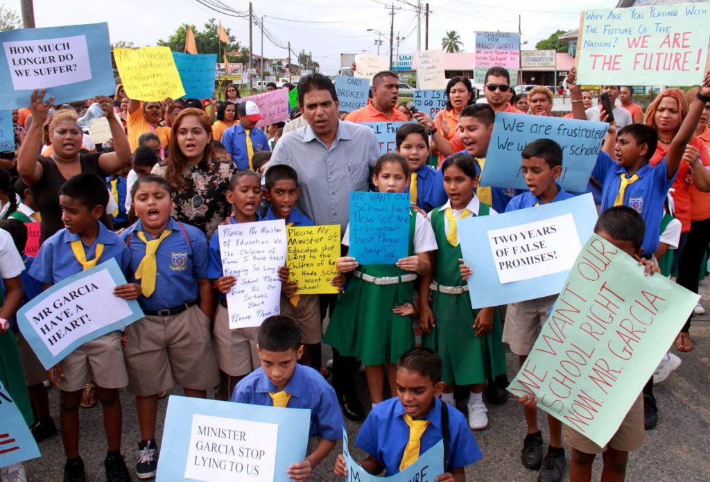 LISTEN TO US: Oropouche East MP Dr Roodal Moonilal among parents 
and students of the Ramai Trace Hindu School who are calling for the 
completion of their new school renamed in Moonilal’s 
honour.