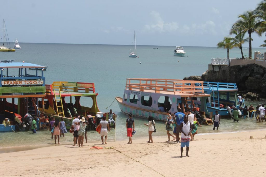 Visitors board glass bottom boats at Store Bay.