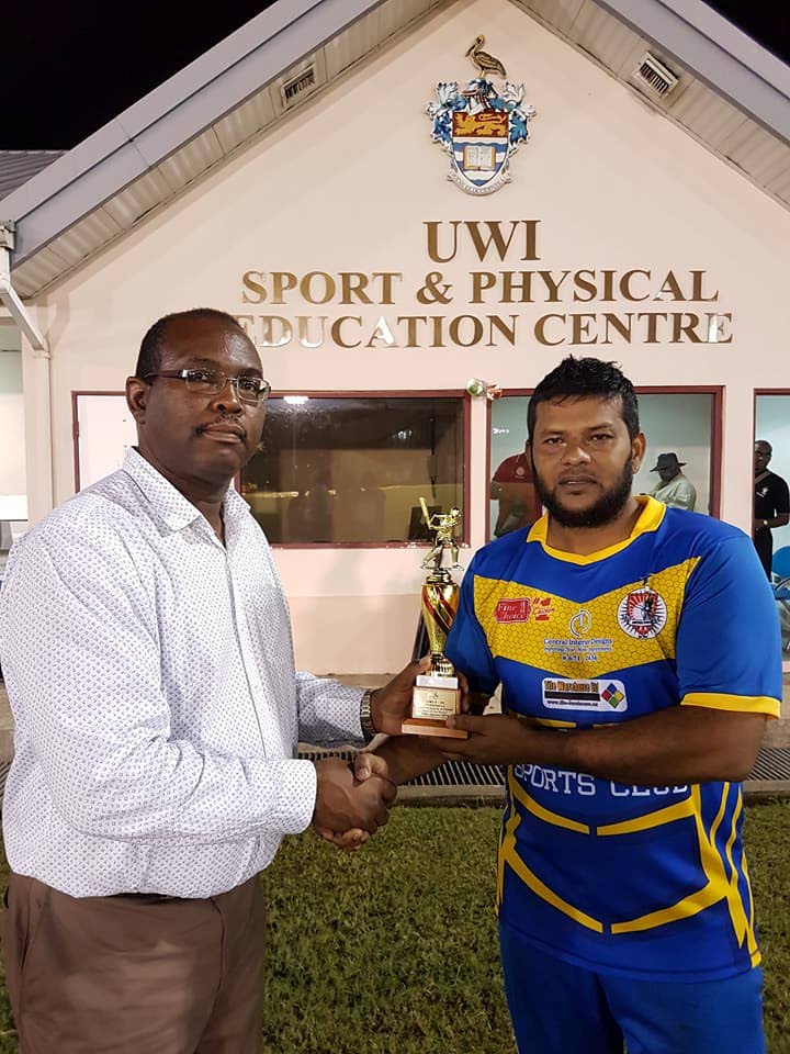Central Sports’ Shazan Babwah, right, collects his Man of the Match award after leading his team into the UWI-UNICOM T20 semi-final on Tueday evening.
