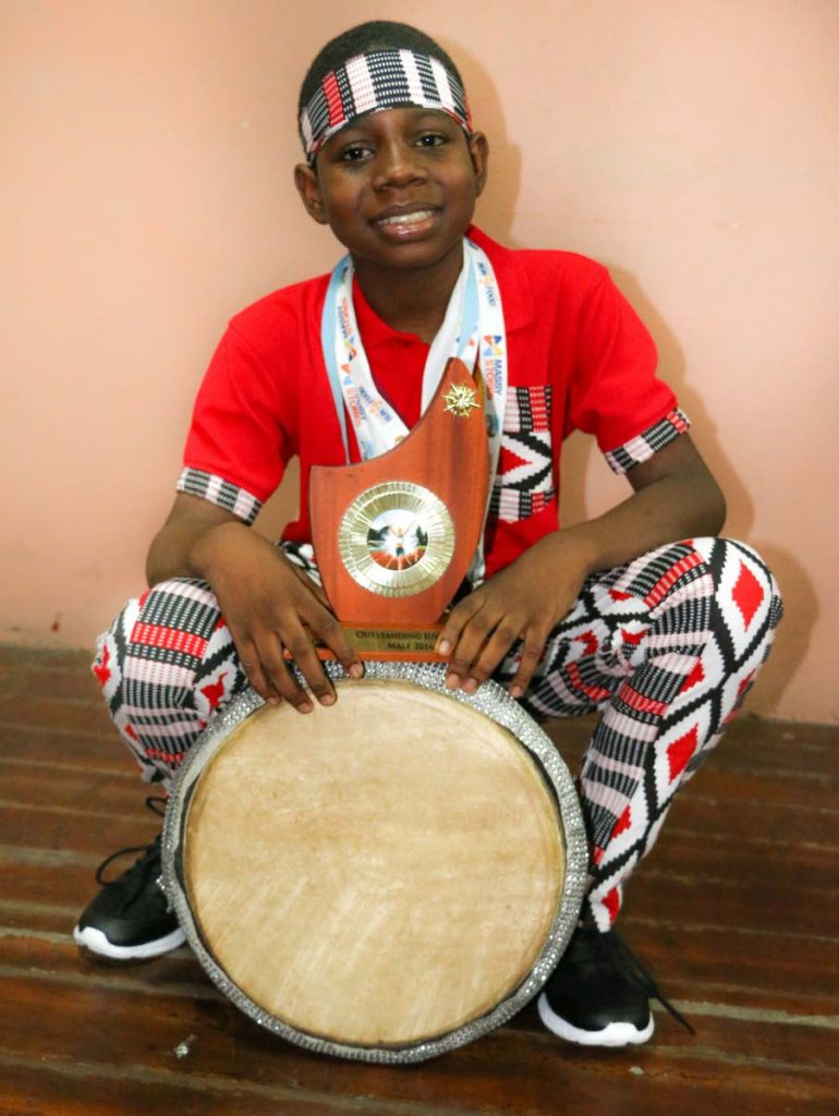 Super-talented: Aydan De Bique is as proud of his awards and medals for track and field as he is of his drum with which he won competitions as a member of Sacred Heart Boys' RC School's drumology group. Photo by Elizabeth Bissessar. 