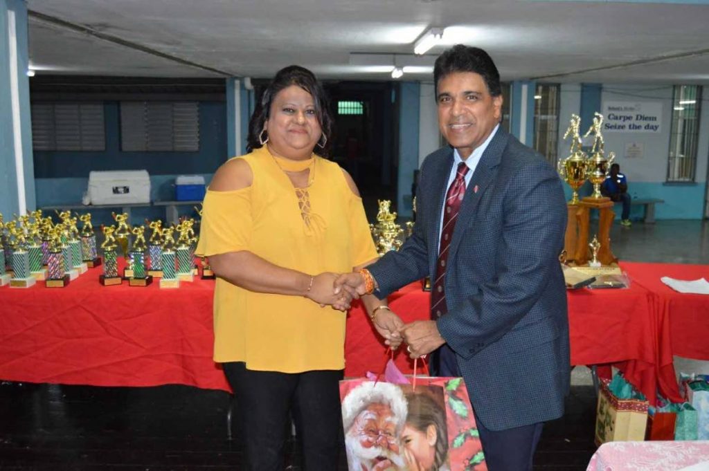 Wife of SSCL president Krishna Bedassie, Ena Bedassie presents Oropouche MP Dr Roodal Moonilal with a token of appreciation  recently at the Southern Sports Cricket League prize-giving.