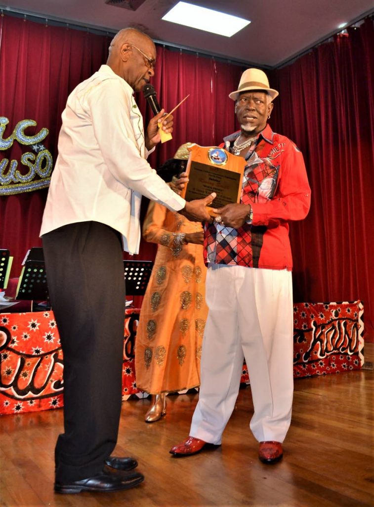Contender presents Black Prince with an award for his service to calypso at the opening of the  Klassic Ruso Calypso Tent in January at City Hall, Port of Spain.
