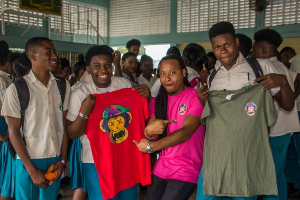 Montage Productions and Way Up 868 clothing managing director, Romano Francois, second right, with Morvant Laventille Secondary School students who participated in the ABC Project initiative at their school last Tuesday. The students won T-shirts from Francois' company. 