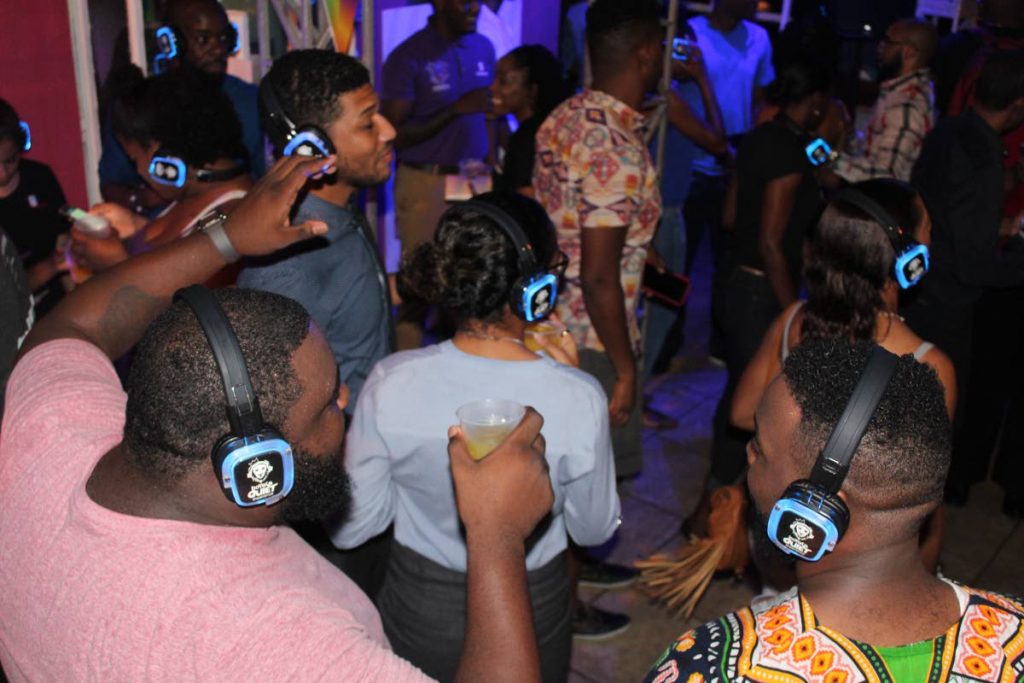 Silent party: Island People revellers dance to music on their headphones in a silent part at the promoter's headquarters on Tragerete Road, Port of Spain on Friday night. Photo by Enrique Assoon. 