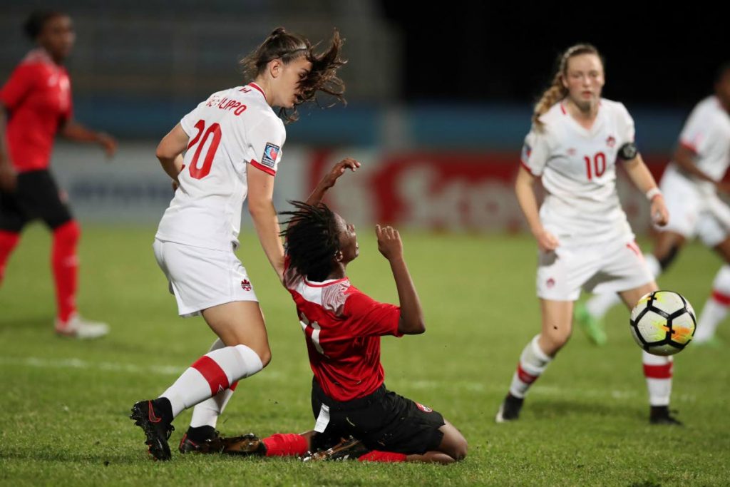 TT midfielder Ranae Ward goes to ground during action on Saturday against Canada in the CONCACAF U20 Women’s Championships at the Ato Boldon Stadium, Couva. Canada won the match 4-1.