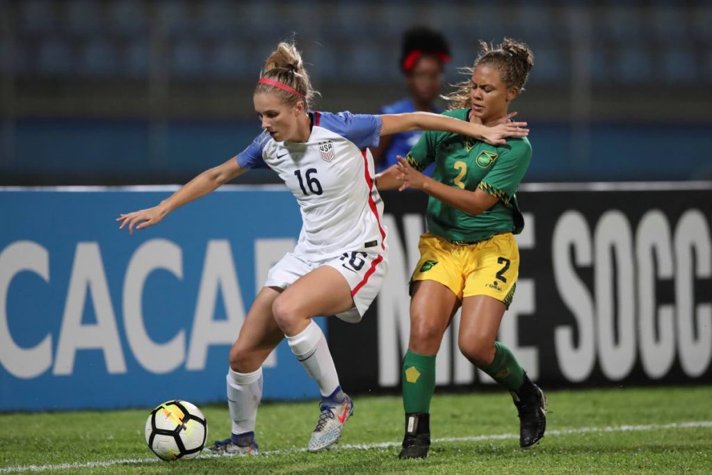 Jamaican defender Madiya Harriot vies for the ball against USA’s Kelsey Turnbow is CONCACAF U20 Women’s Championships action on Sunday night at the Ato Boldon Stadium. USA won 2-1.