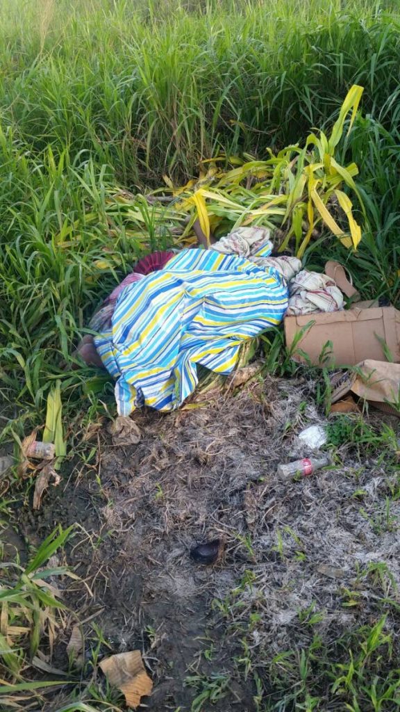 DUMPED: The bedsheets under which, the bodies of an unidentified man and woman were found yesterday at Mon Plasir Road in Cunupia.