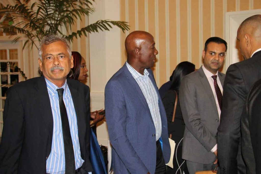 Prime Minister Dr Keith Rowley speaks with Caribbean Airlines chairman Shameer Ronnie Mohammed at a meeting held at the Magdalena Grand Beach and Golf Resort.