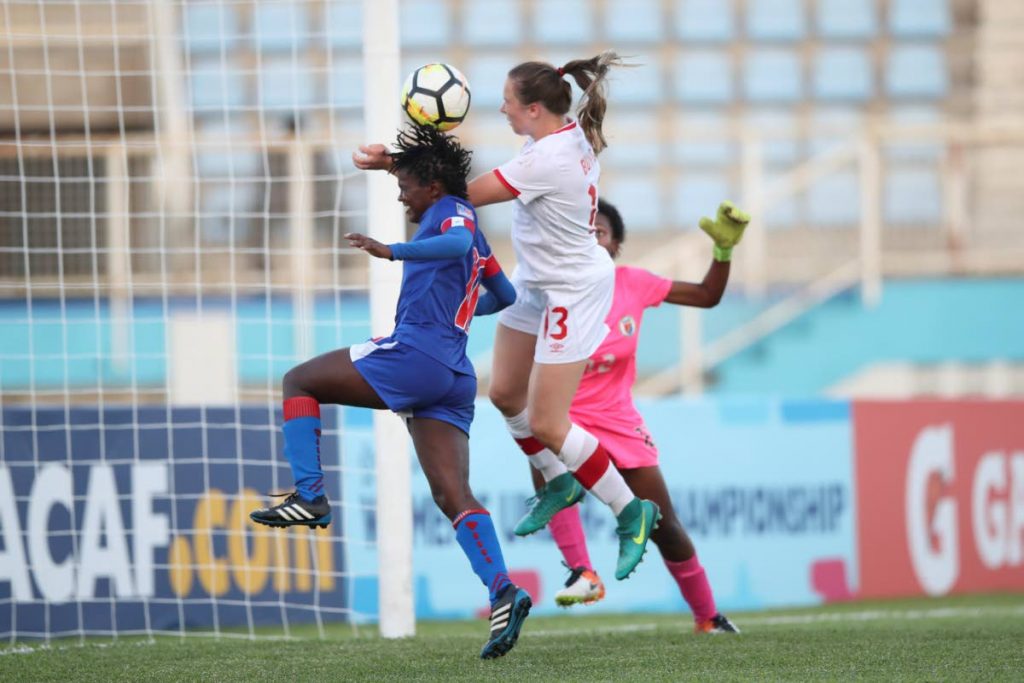 Canada’s Tanya Boychuk (13) heads the ball to goal against Haiti yesterday at the Ato Boldon Stadium during action in the CONCACAF Women’s U20.
