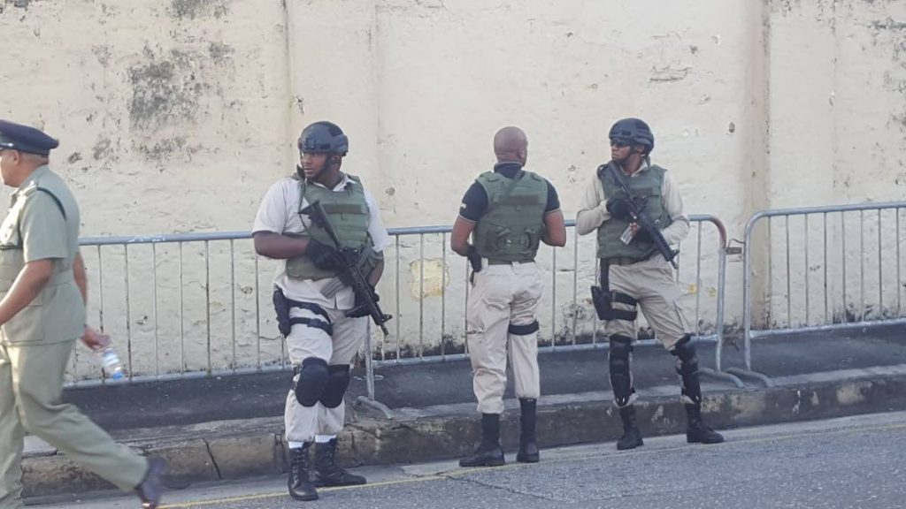 Heavily armed prison officers outside the Port of Spain prison on Frederick Street yesterday.