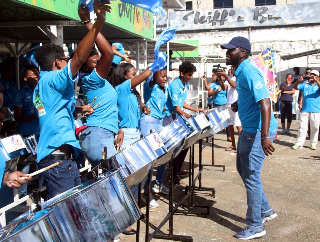 PAN RISING: Naps Combined Steel Orchestra members are jubilant during their performance of Falling, sung by Kees Dieffenthaller, at the Skiffle panyard on Coffee Street, San Fernando yesterday.  The band participated for the first time in the National Junior Panorama competition.