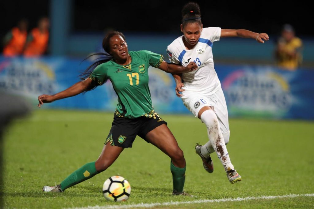 Jamaica’s Jazmin Grant and Nicaragua’s Yorcelly Humphrey’s battle for the ball in their encounter at the Ato Boldon Stadium, Couva on Tuesday. That match ended 2-2.