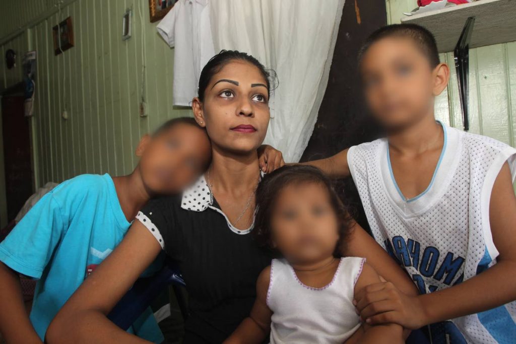 Selena Khan with her children at their old Cunupia apartment home.  They had to find new lodgings after Khan received an eviction notice.