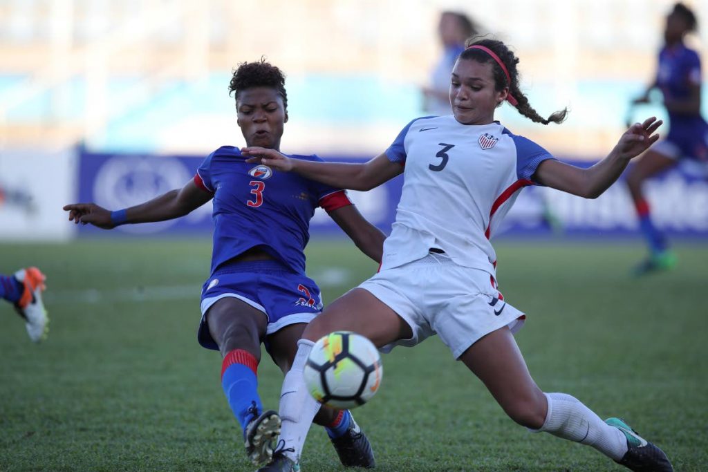 USA striker Sophia Smith,right, battles for the ball with Haiti defender 
Naphtaline Clemeus in their semi-final match in the CONCACAF Women’s U20 Championships yesterday at the Ato Boldon Stadium, Couva.