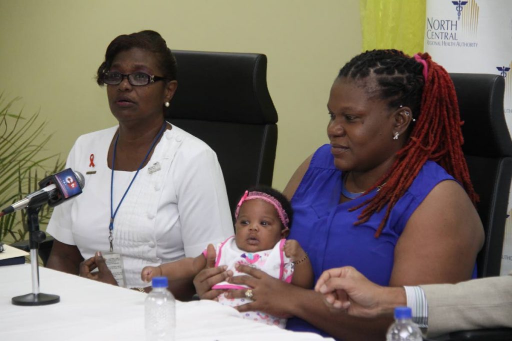 A nurse's care: A midwife sits alongside Roxanne Applewhite and her baby girl Imani during the launch of the NCRHA post natal home care programme on January 21.