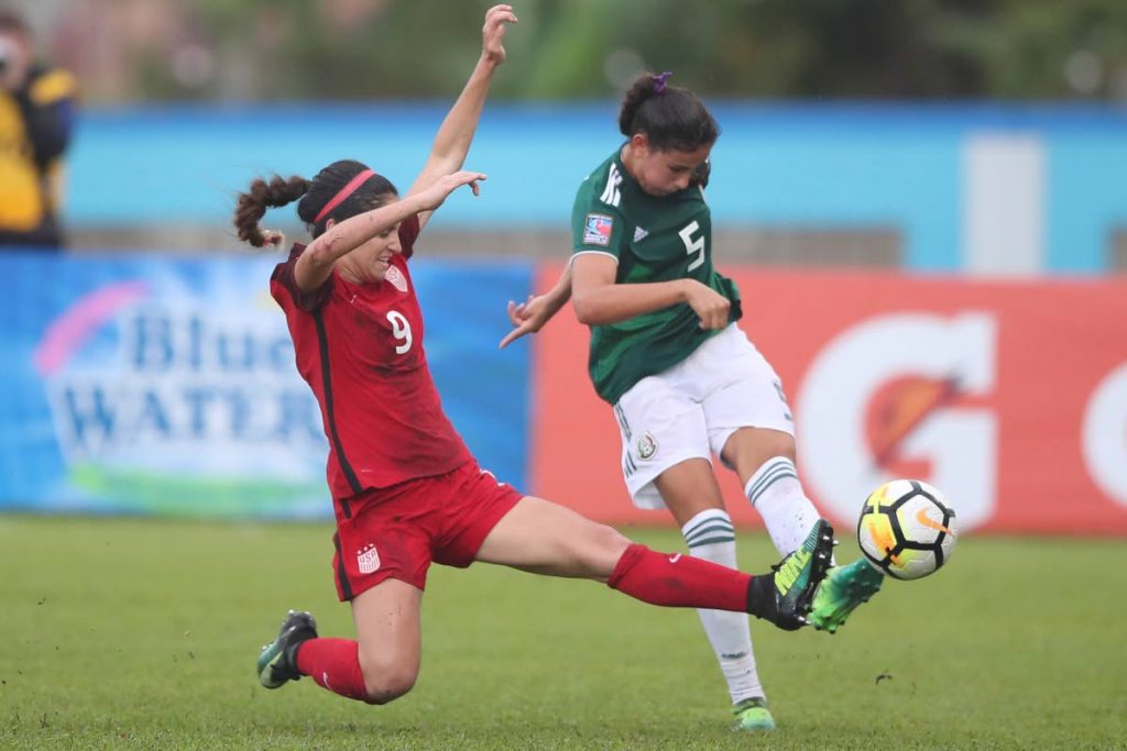 Mexico’s Jimena Lopez, right, shoots as USA’s DeMelo Savannah looks to block in the CONCACAF Women’s U-20 final at the Ato Boldon Stadium, Couva, yesterday.