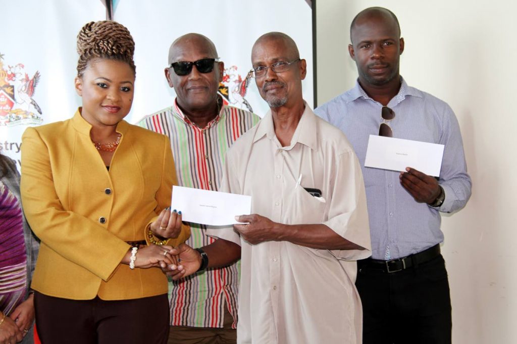 Minister of Community Development , Culture and Arts, Nyan Gabsby-Dolly presents cheque to David Balbosa of the South Central region, Carlan Harewood right,  for the Northern region, and looking on is, 2nd from left, Pan Trinbago president Keith Diaz. Photo: Spain SUREASH CHOLAI