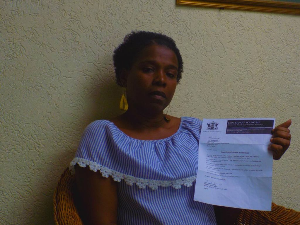 Cathrina Yearwood displays a letter by Port of Spain North MP Stuart Young asking for the Housing Development Corporation to review her application after her home was destroyed by fire last year. PHOTO BY SHANE SUPERVILLE.