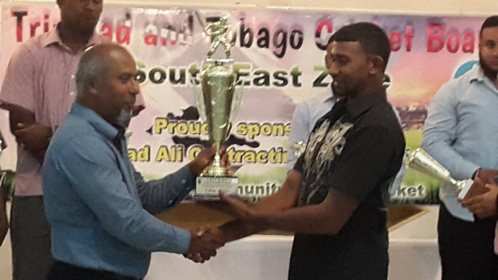 Sponsor of the South East Zone competitions, Ashmead Ali, left, presents the Cricketer of the Year trophy to Shane Khan of Sancho/St Julien.