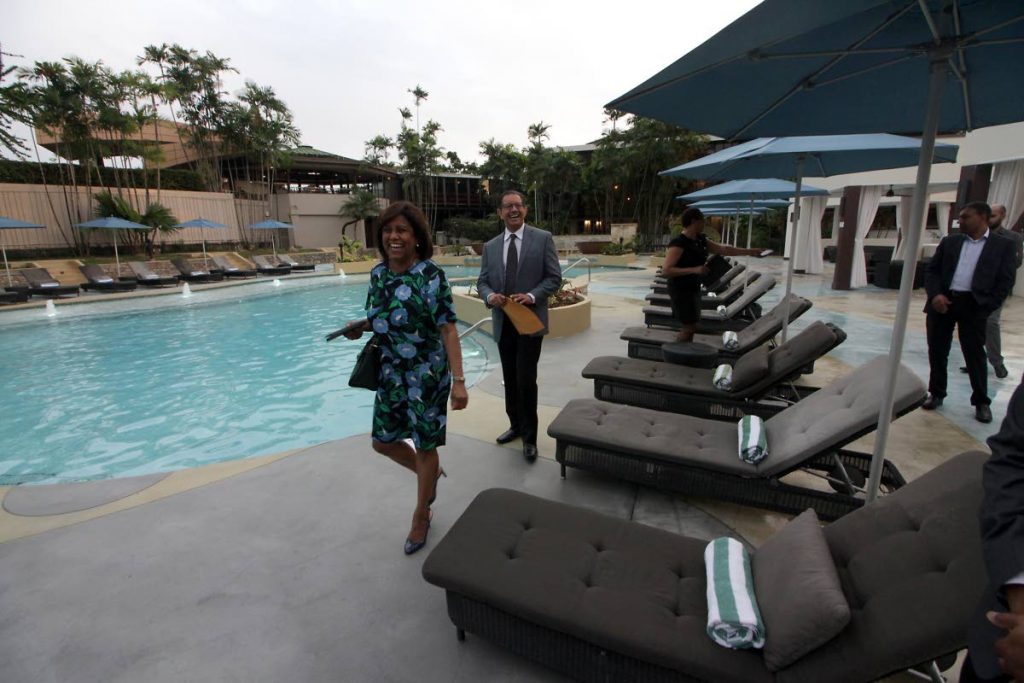 POOLSIDE WALK: Trade Minister Paula Gopee-Scoon and eTecK chairman Imtiaz Ahamad have a look at the renovated pool at the Trinidad Hilton and Conference Centre on Monday.   PHOTO BY ROGER JACOB