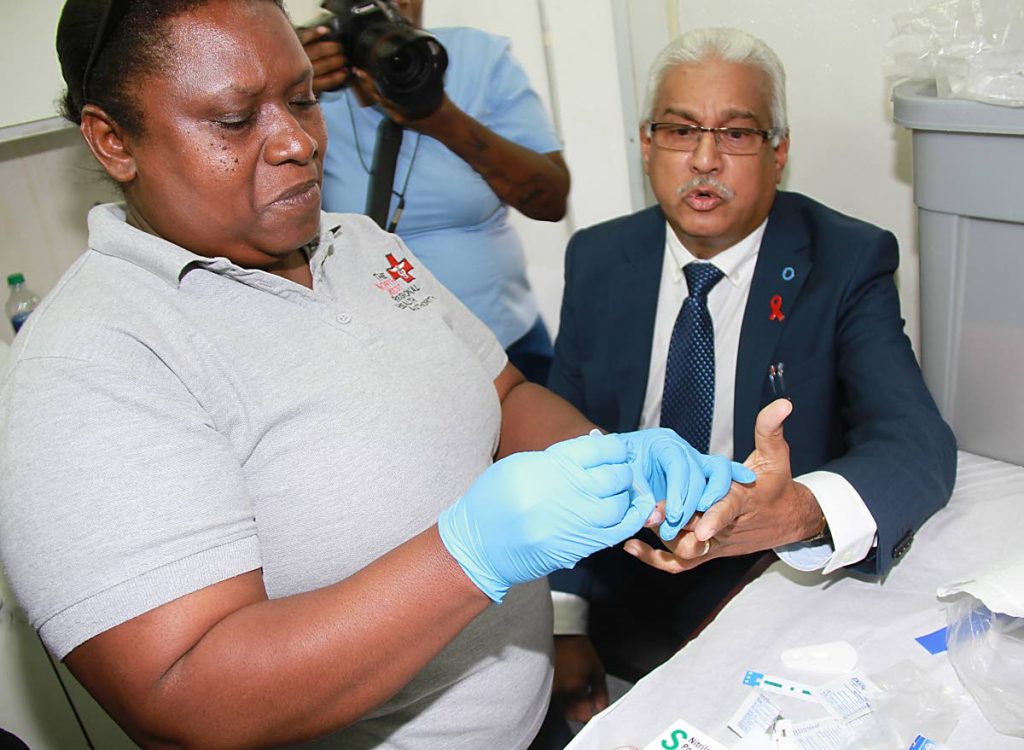 Phlebotomist Sherry Paul takes a blood sample from Health Minister Terrence Deyalsingh for a HIV/Aids test on World Aids Day, Brian Lara Promenade, Port of Spain in 2015. FILE PHOTOS BY ROGER JACOB.