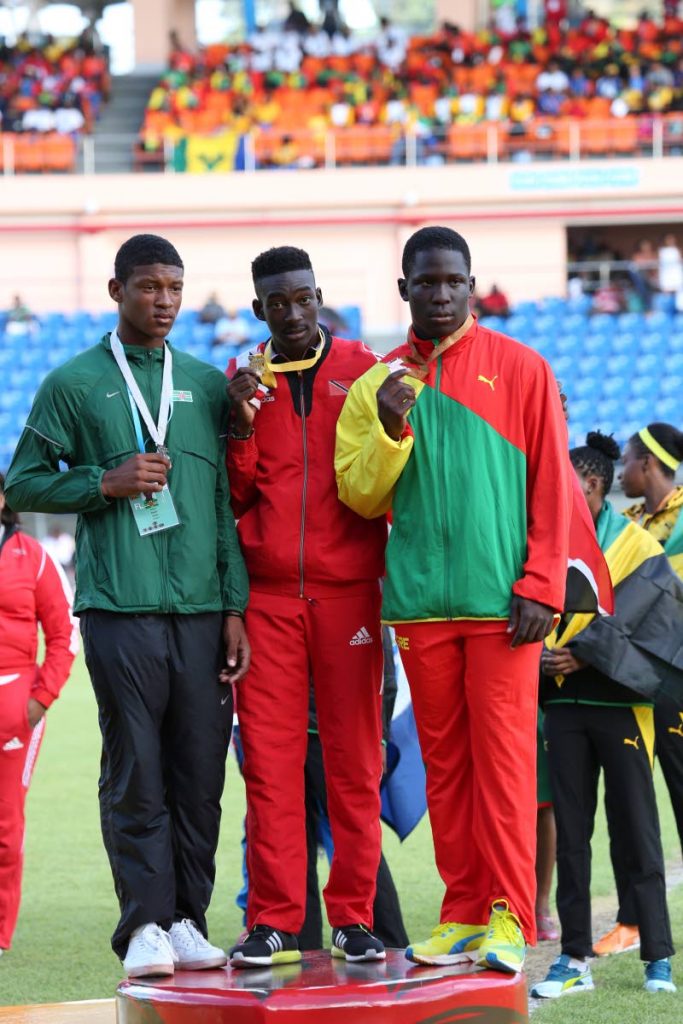 ZENITH CHAMP: In this March 2016 file photo, Tobago’s Zenith javelin champion Tyriq Horsford, centre, shows off his gold medal won in the Boys Under-18 category at CARIFTA Games in Grenada.