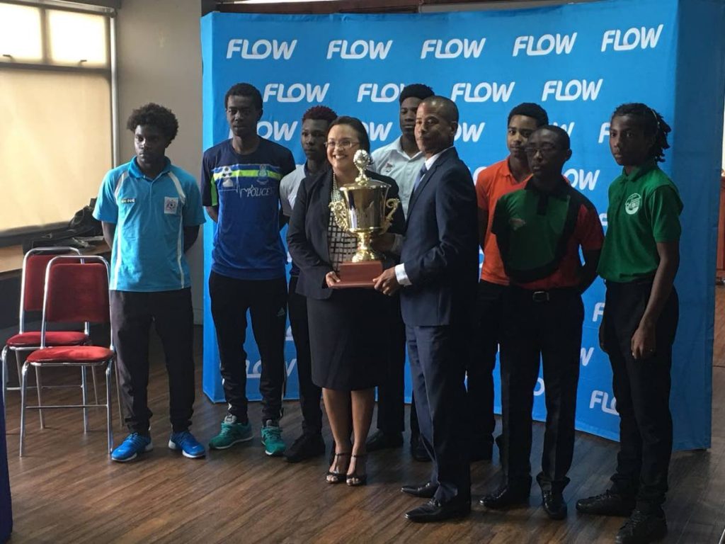 Dexter Skeene, front right, holds the FLOW Youth Pro League trophy with FLOW Director of Marketing, Cindy-Ann Gatt yesterday at the launch of the 2018 season.