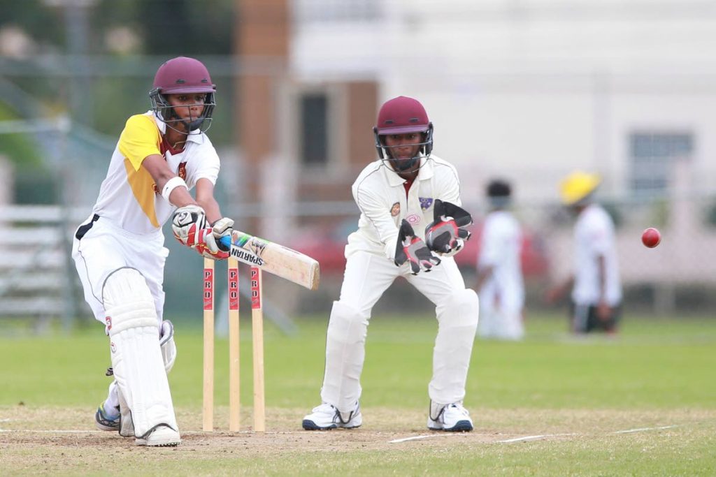 Hillview’s Rickash Boodram makes a shot with St Benedict’s wicketkeeper Antonio Gomez, during the Secondary School’s Cricket League match between Hillview College and St. Benedicts College at UWI SPEC Grounds, St. Augustine.