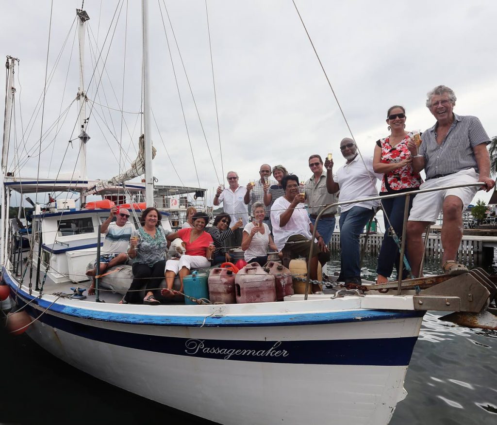 Sea conquerer: Adventurer Peter Quentrall-Thomas celebrates aboard the Passagemaker in Chaguaramas on Friday with his wife and friends after sailing across the Atlantic Ocean. 